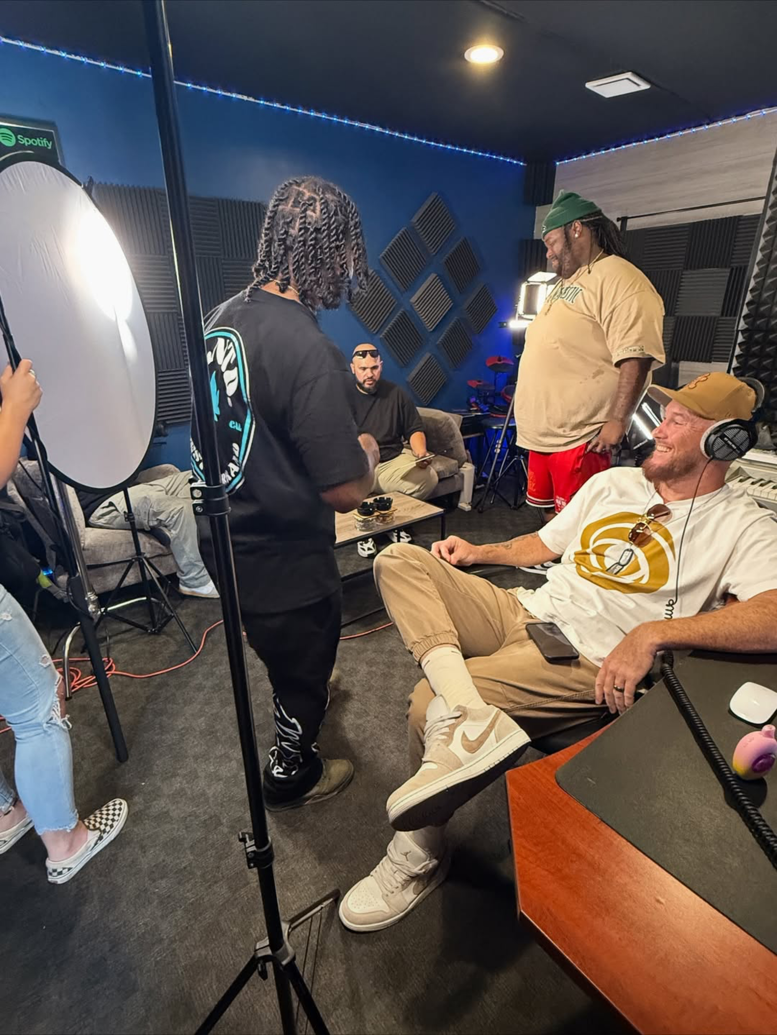 Behind the scenes at Lost and Found Studio, with people and filming equipment in a recording room